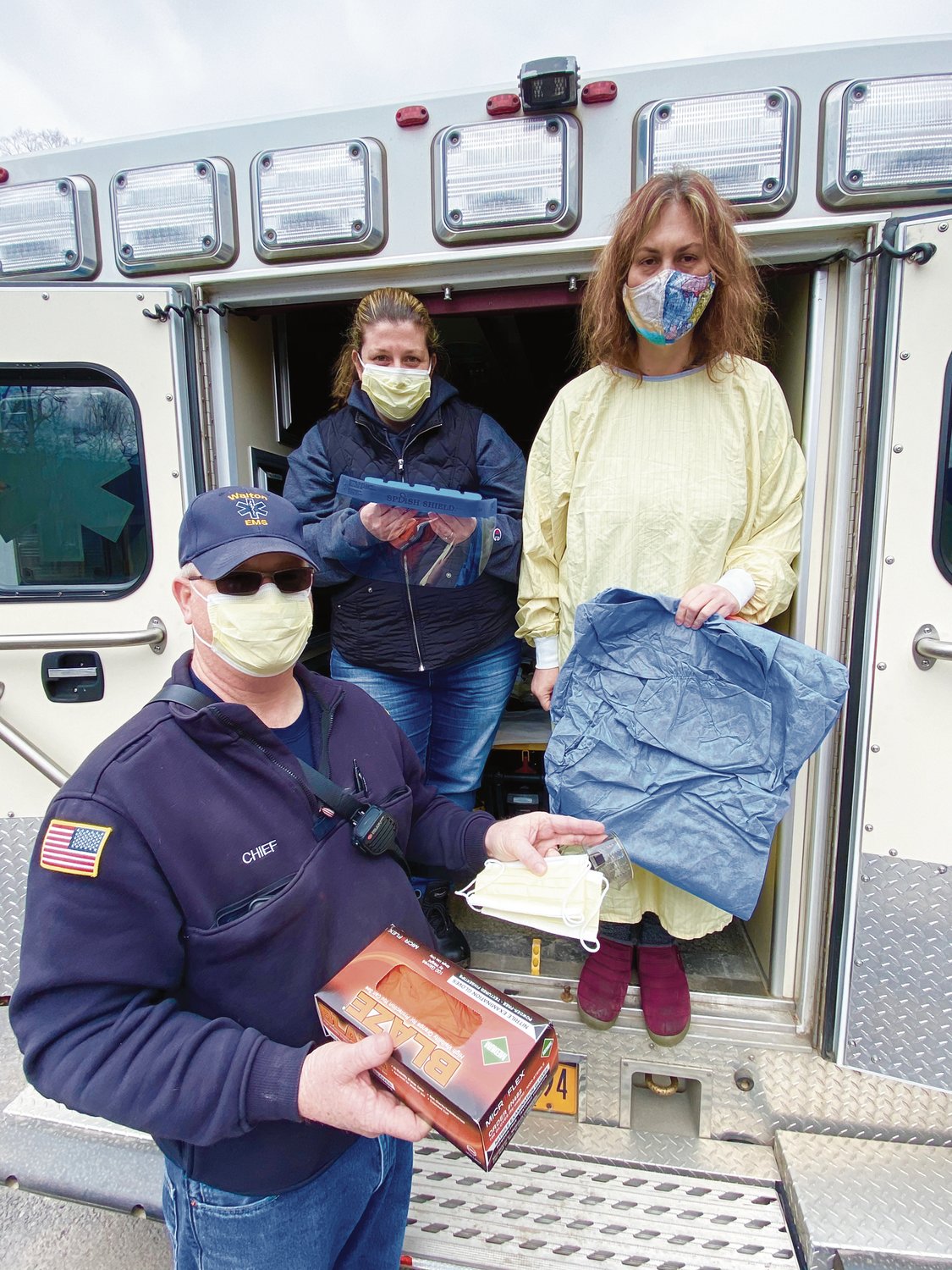 Walton Fire Chief Frank Wood, EMS Squad Captain Jessica Gilmore and Volunteer Maureen Babcock display the PPE (personal protective equipment) donated by Walton businesses and individuals.